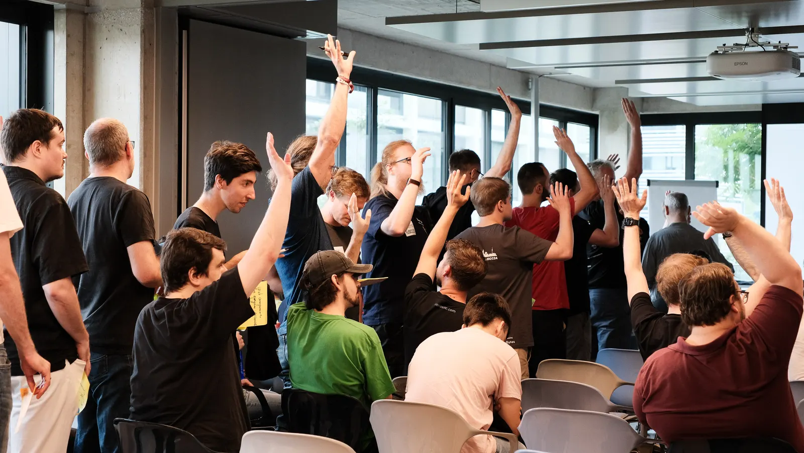 Many hands in the air while voting on sessions