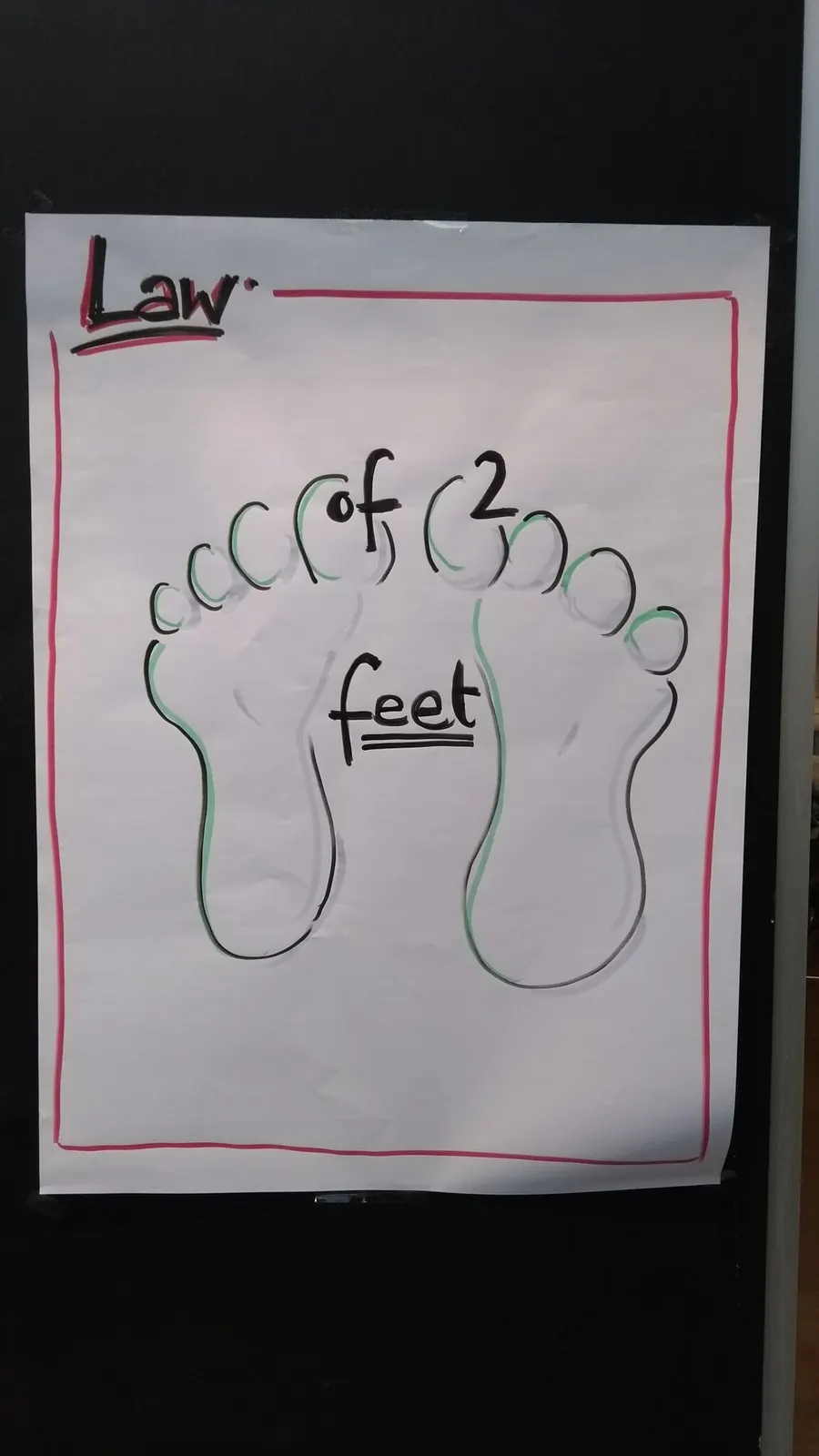 Poster “Law of two feet” with two drawn footprints